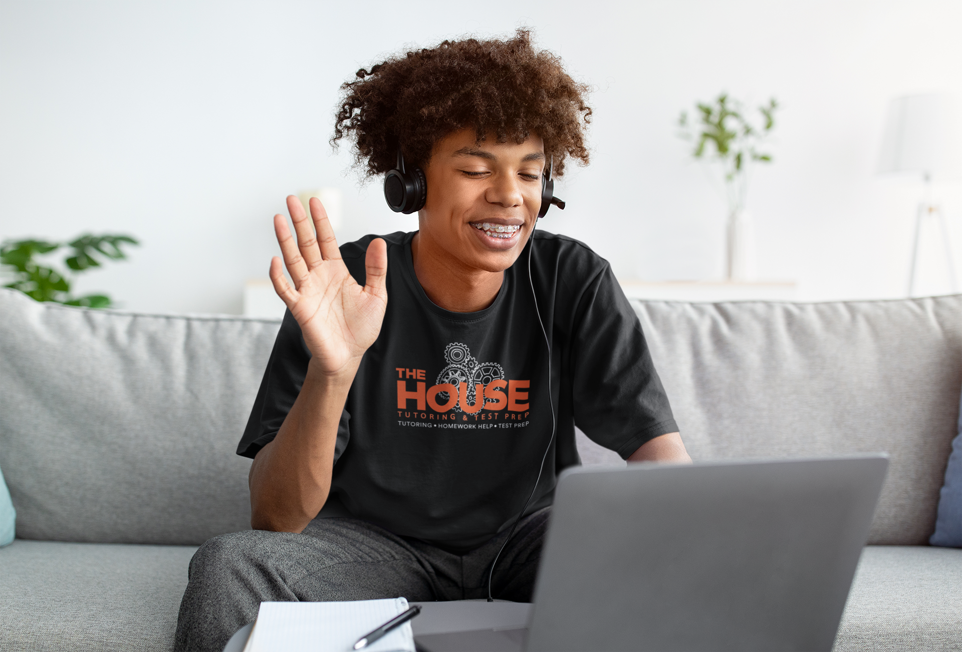 t-shirt-mockup-of-a-teenage-boy-with-braces-doing-a-conference-call-at-home-m16320-r-el2
