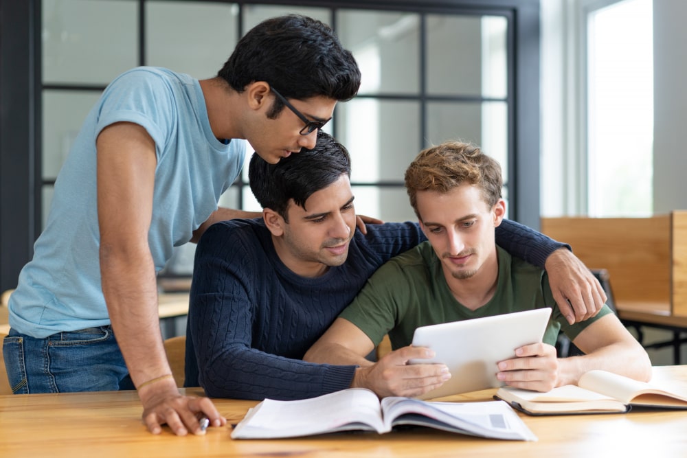 group-friends-studying-together-helping-each-other-min