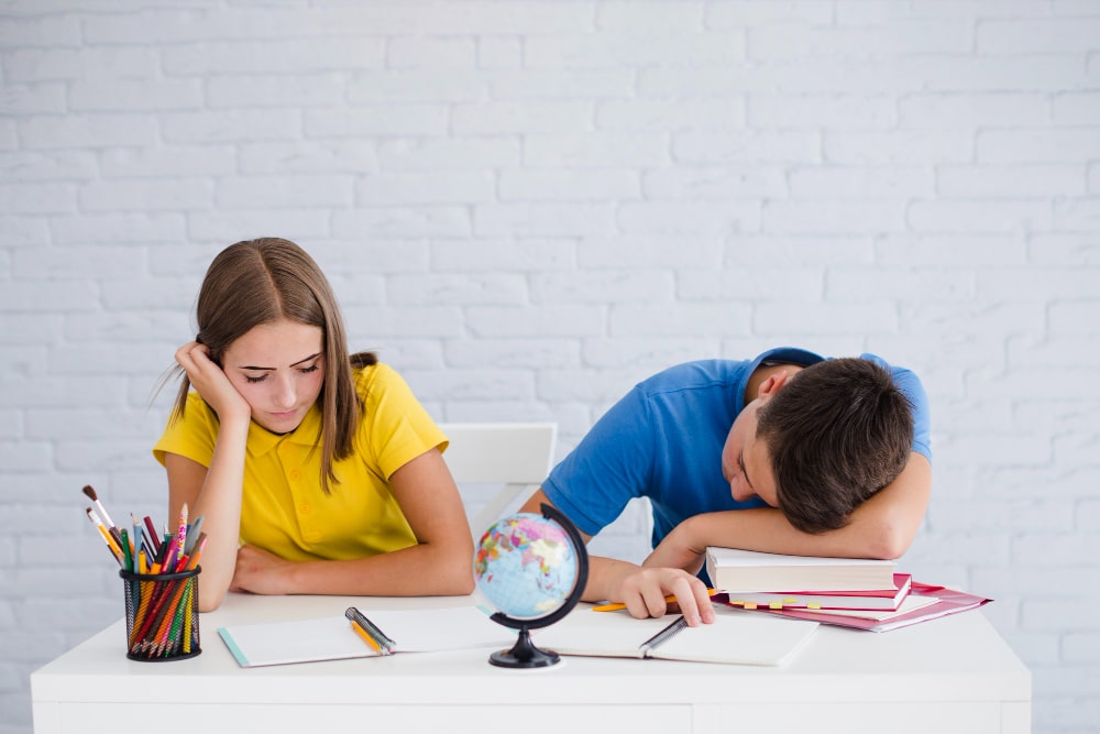 teenagers-sleeping-during-lesson-min